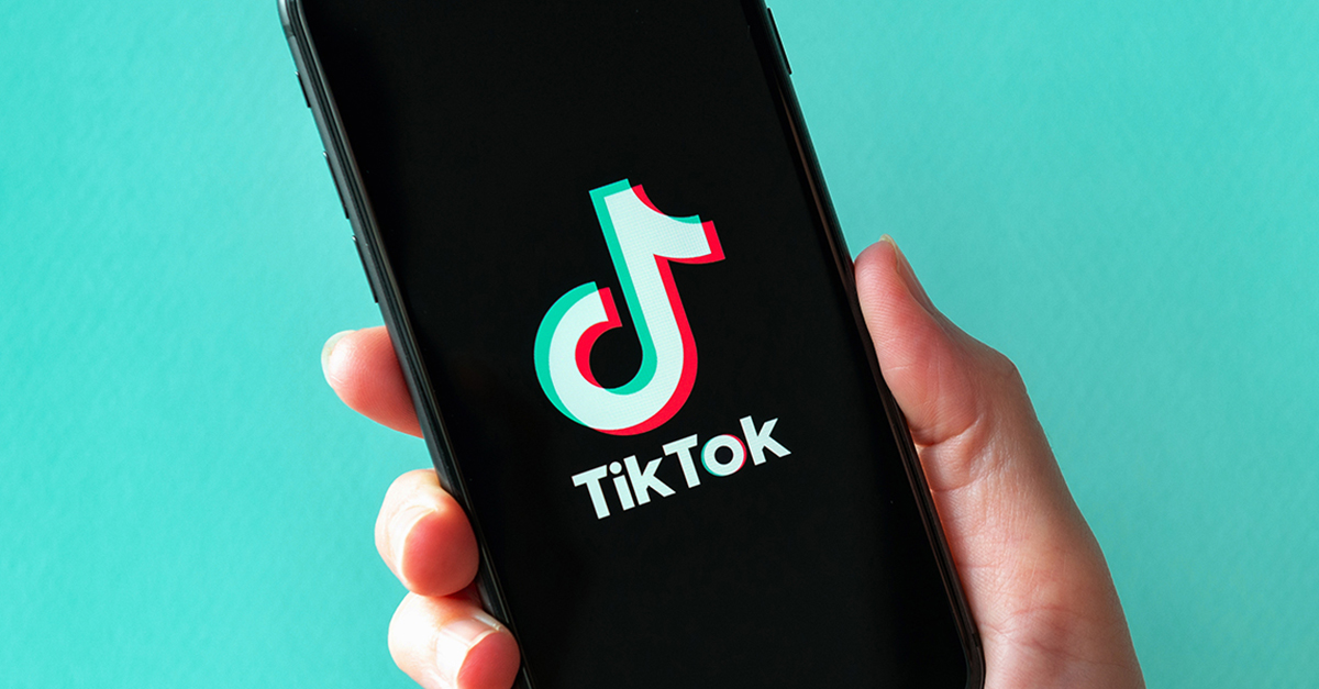 Person Holding Phone Opening TikTok App